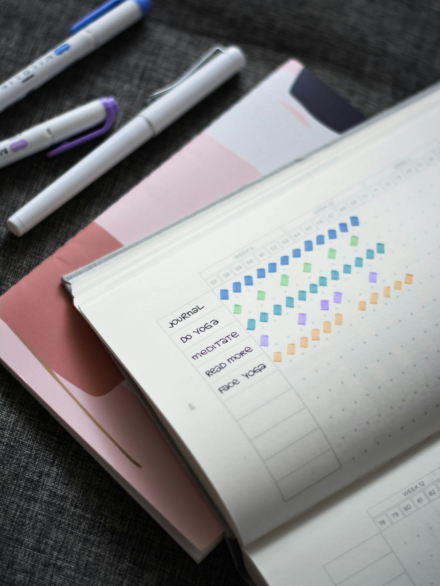 three different types of pens sitting on top of a folder