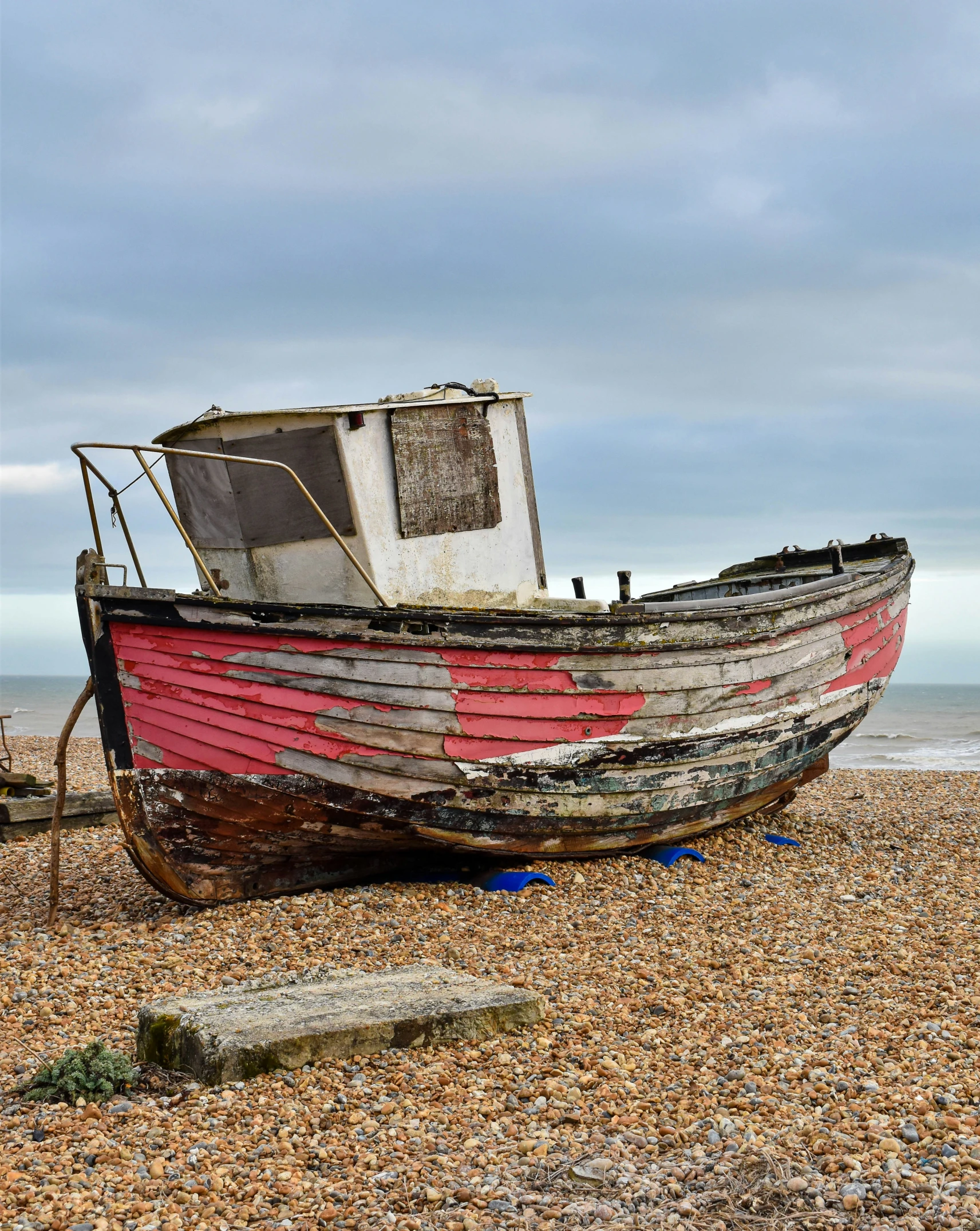 a small boat on the beach in the sand