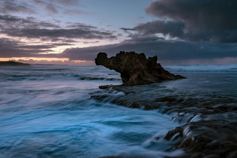 a very large rock out in the water