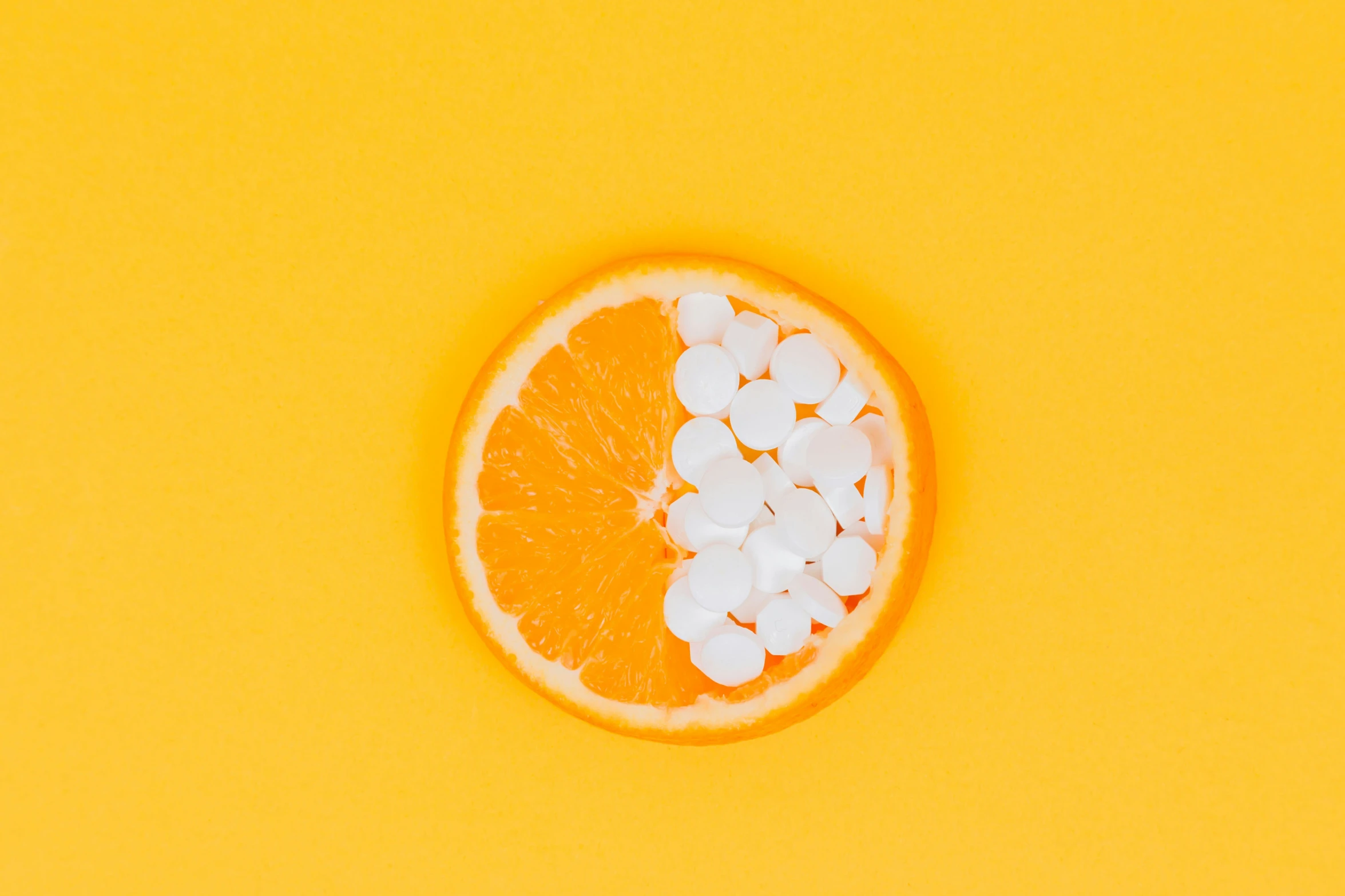 a sliced orange that is half filled with marshmallows