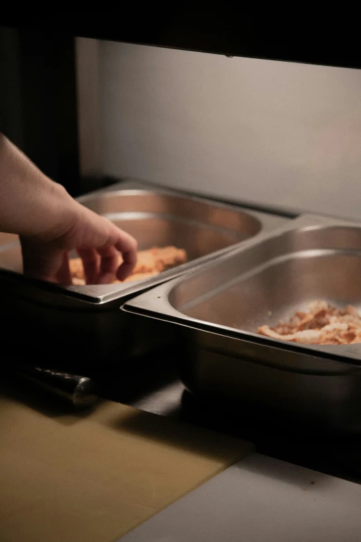 two pans containing food being cooked in an oven