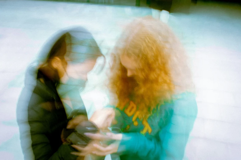 two women standing in front of each other talking