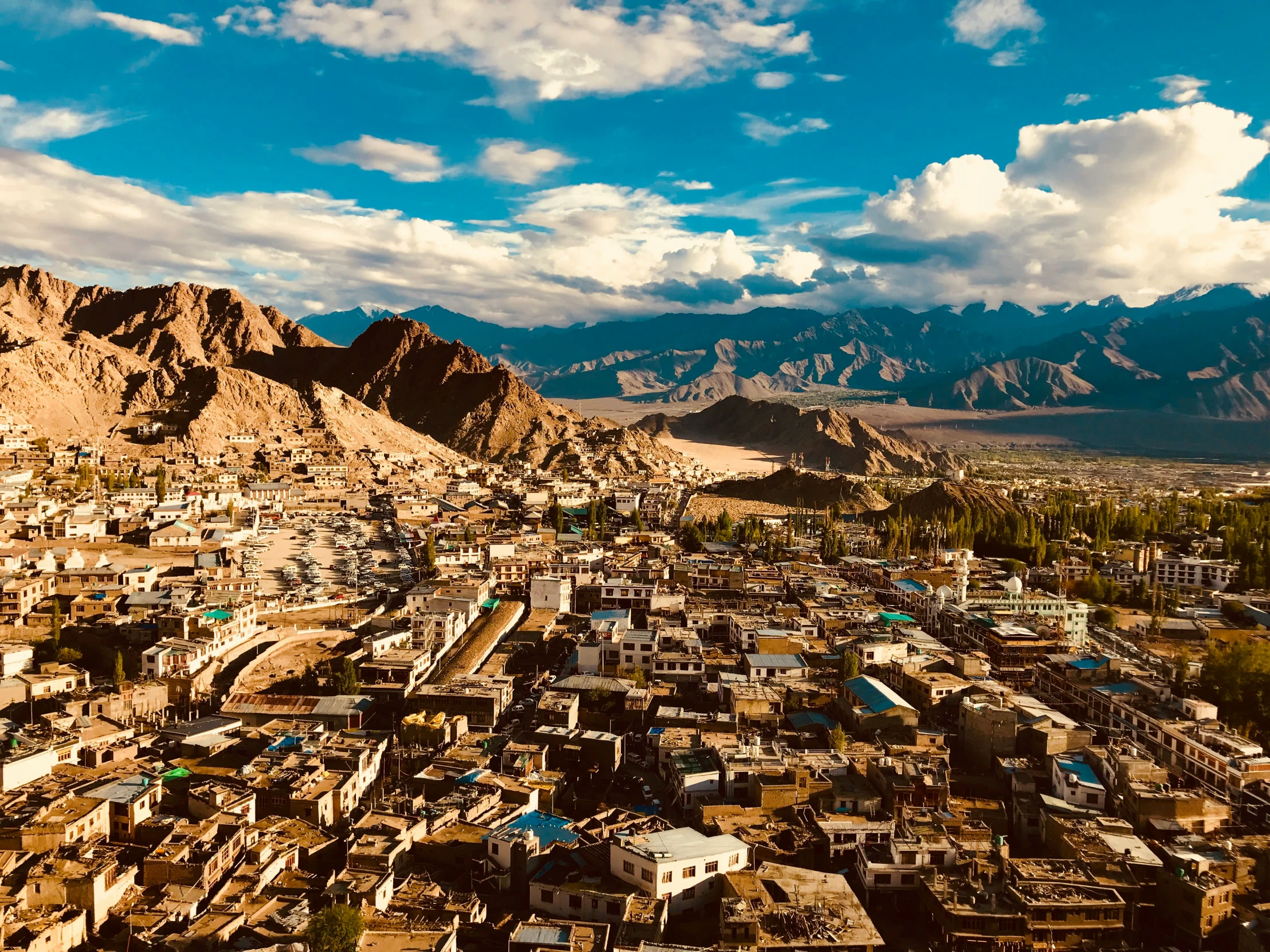 a cityscape with mountains in the distance