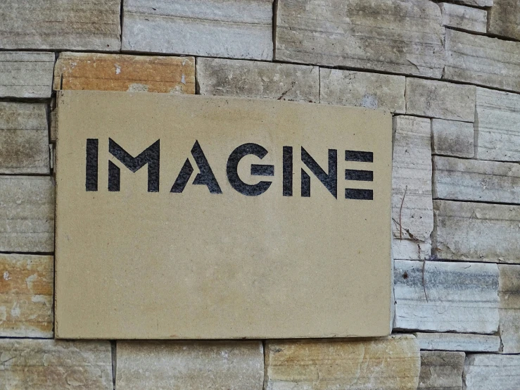 a sign on the outside of an old building saying imagine