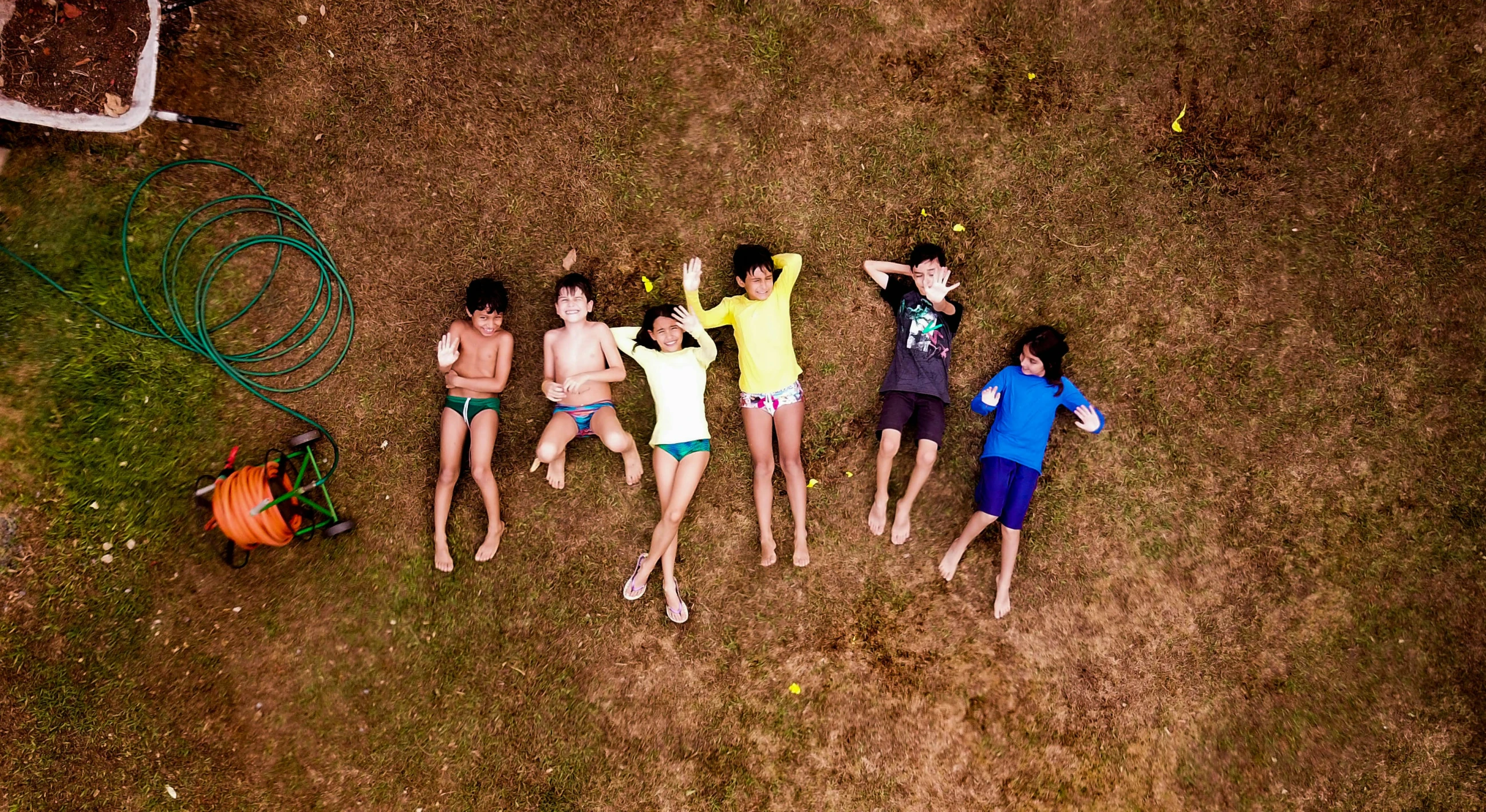 five people standing in a field with an air balloon