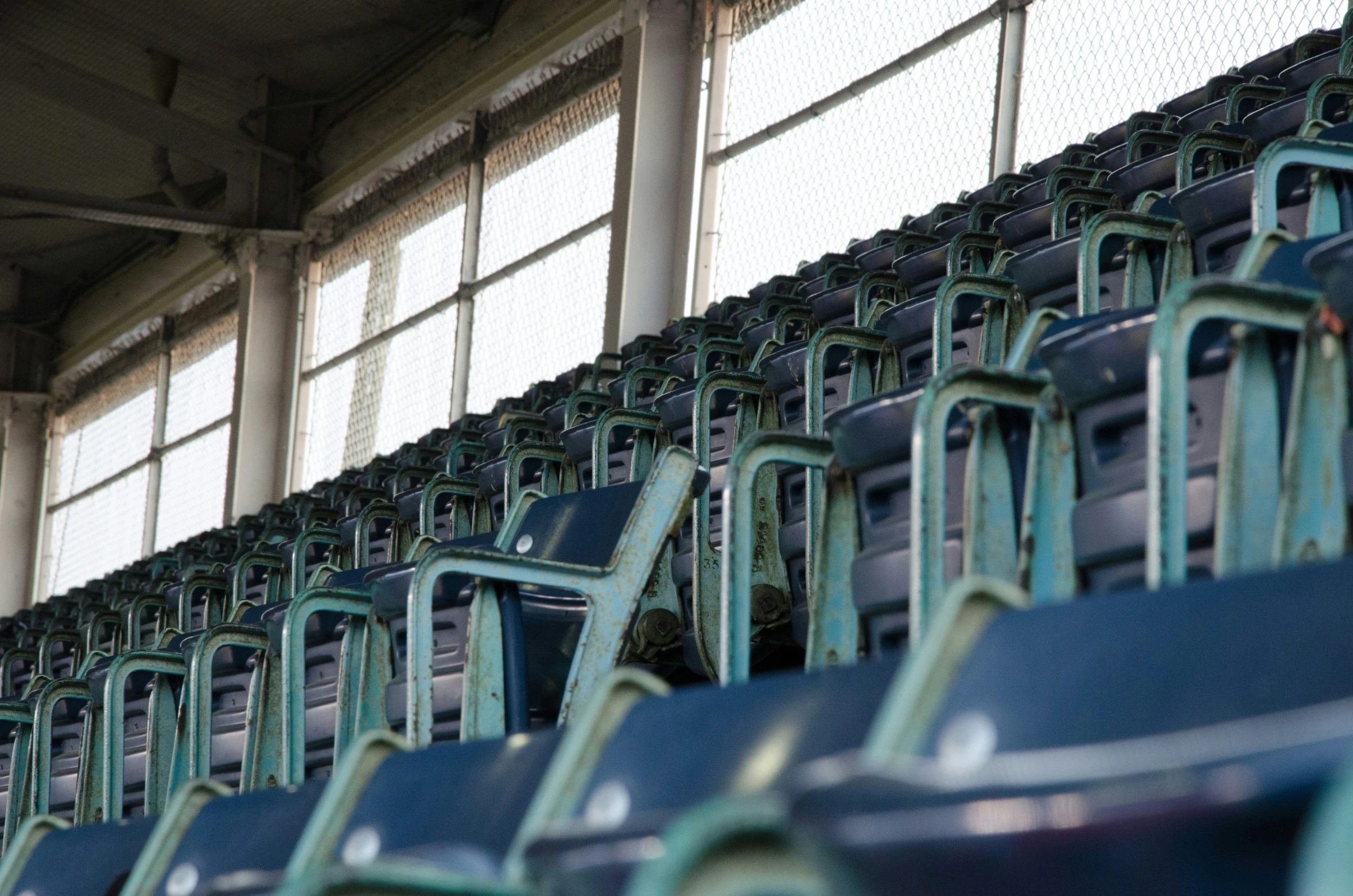 a row of seats in an empty baseball stadium