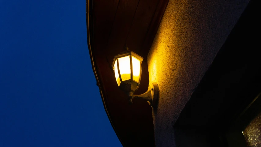a street light sitting under a dark blue sky