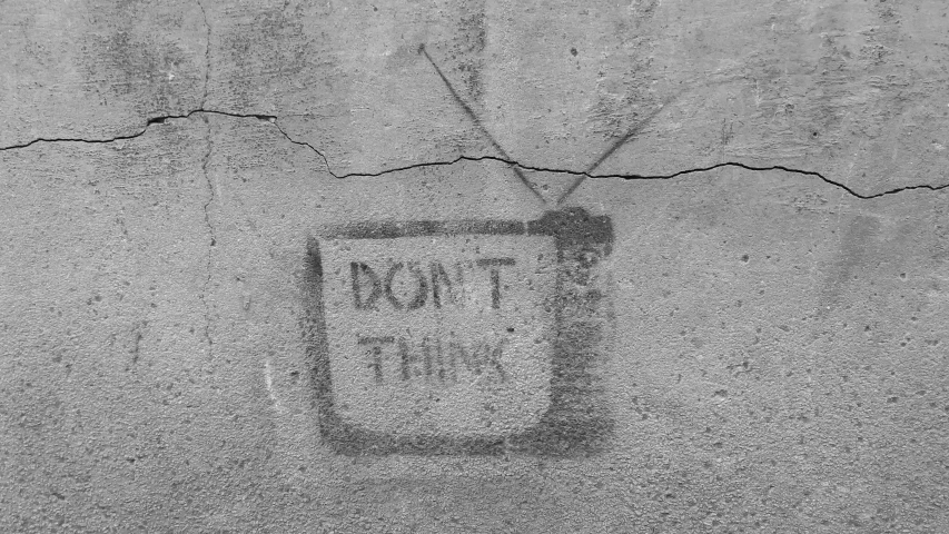 graffiti drawing on the side of a stone wall saying not to put