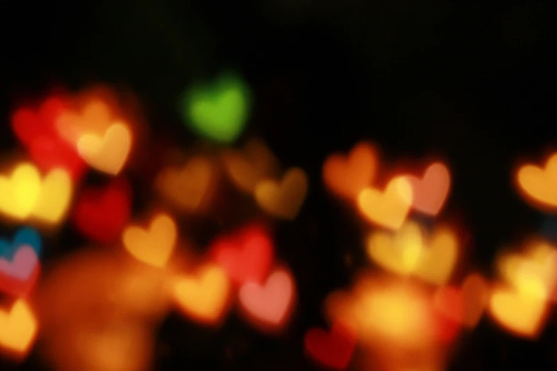 blurred heart shaped lights that can be seen in a window