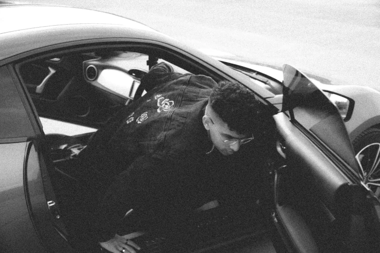 a man is sitting in the passenger seat of a car