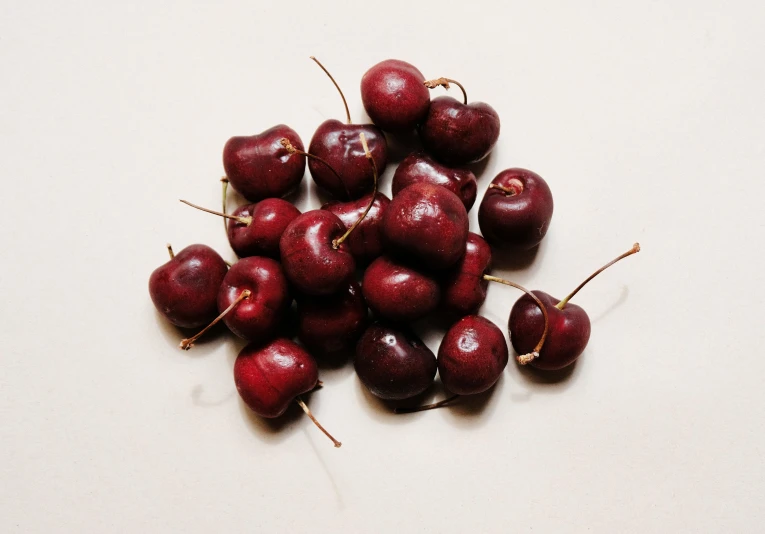 a pile of cherries sitting on top of each other