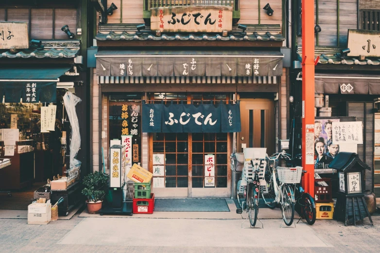 the outside of an asian shop with bikes in front