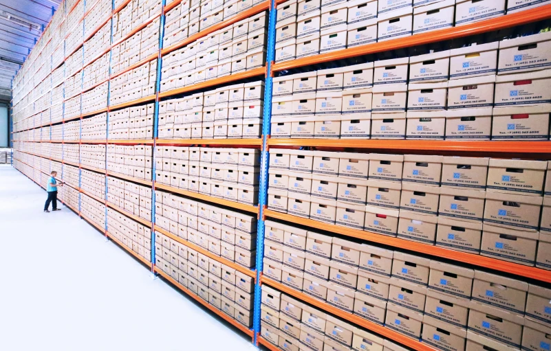 a man standing in front of stacks of boxes