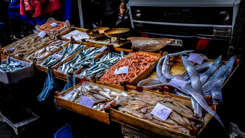 various types of food at a stand in the dark