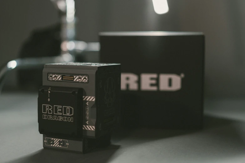 a box that says red sits on top of a desk