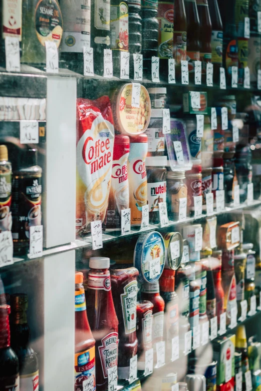 many alcoholic drinks are arranged together on shelves