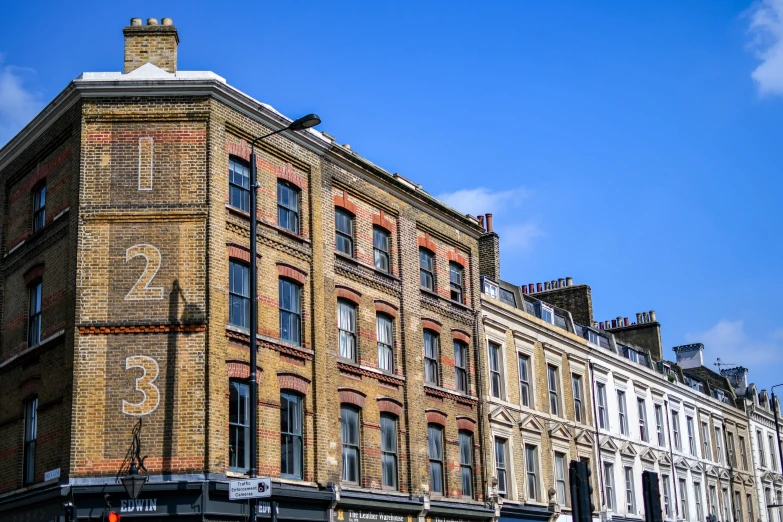 a tall brick building with a clock on the top