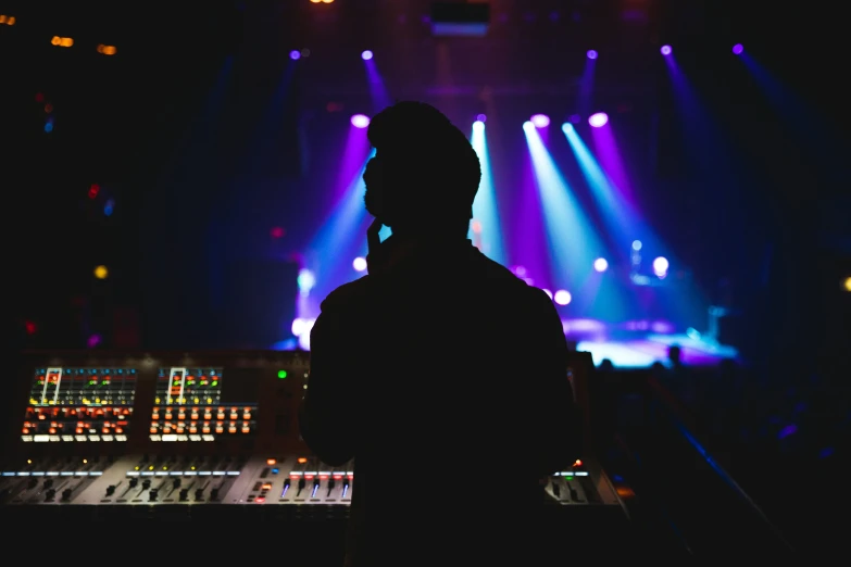 a man in front of some brightly colored lights