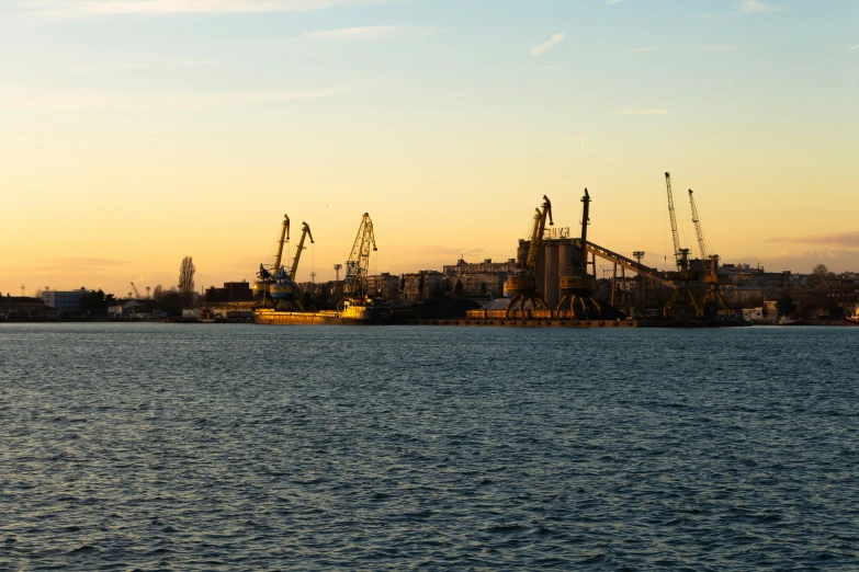 ships are docked on the harbor with sky in the background