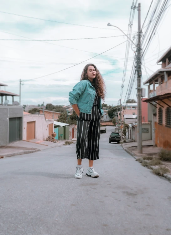 a  wearing overalls stands alone on the street