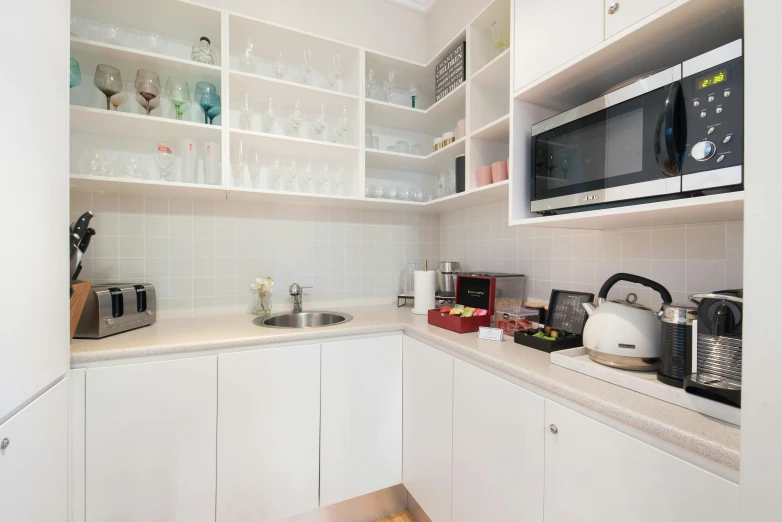 a microwave sitting on top of a wall next to a counter