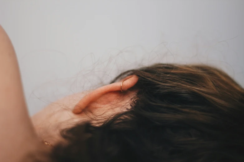 closeup of a persons hair and a cell phone