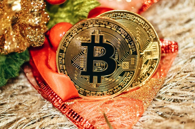 a golden bit coin surrounded by holiday decorations