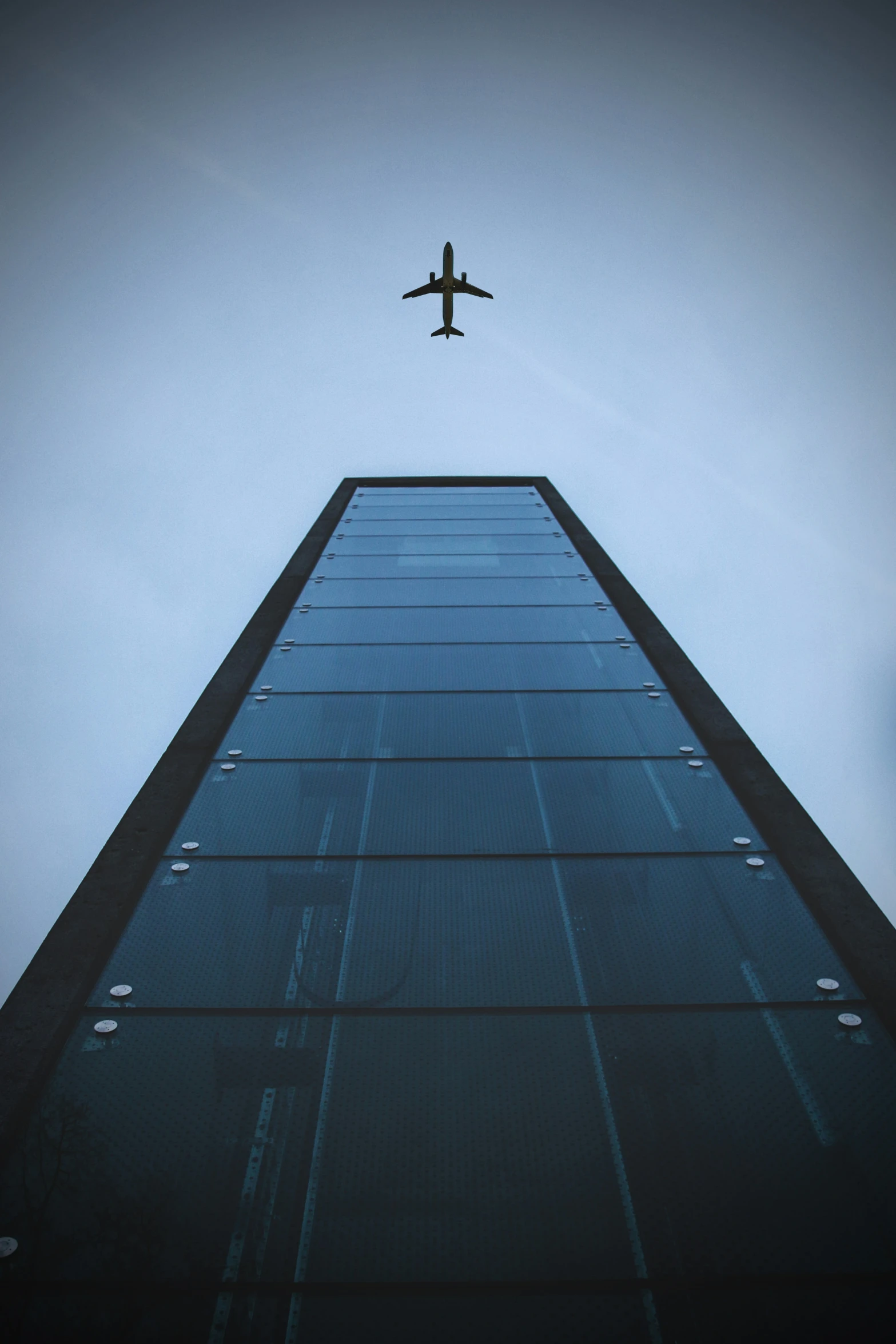 airplane in the sky above an office building