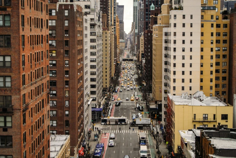 looking down a city street with multiple large buildings