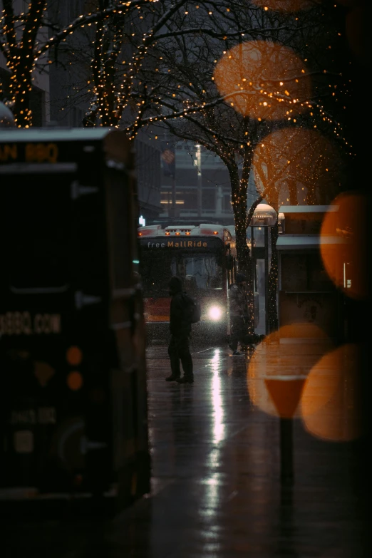 a person is walking down the sidewalk with umbrellas