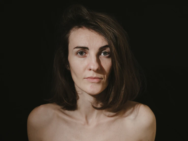 a woman's face is shown with a black background