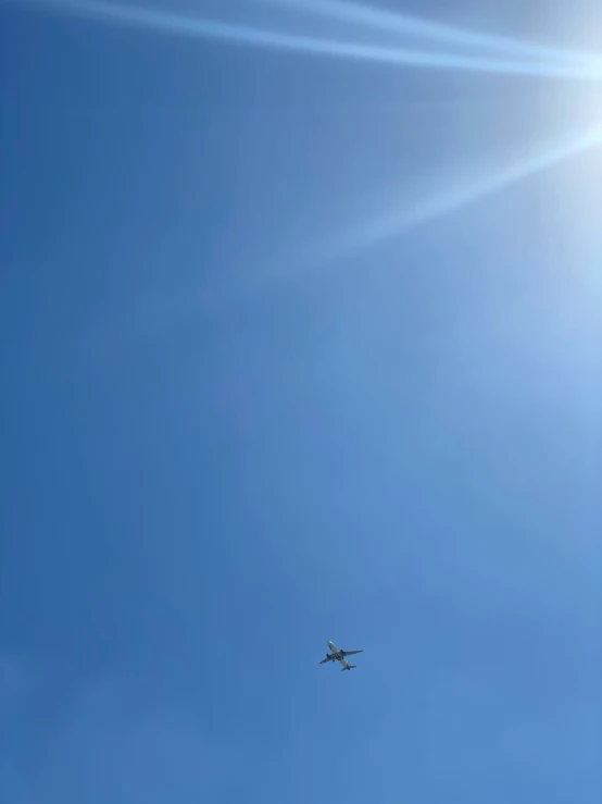 a commercial airplane flying in a clear, blue sky