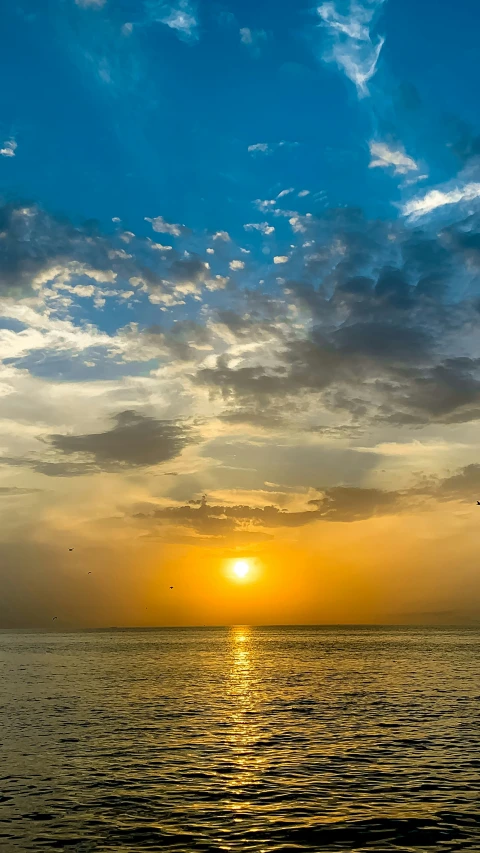 the sun is shining brightly behind the clouds in a sunset