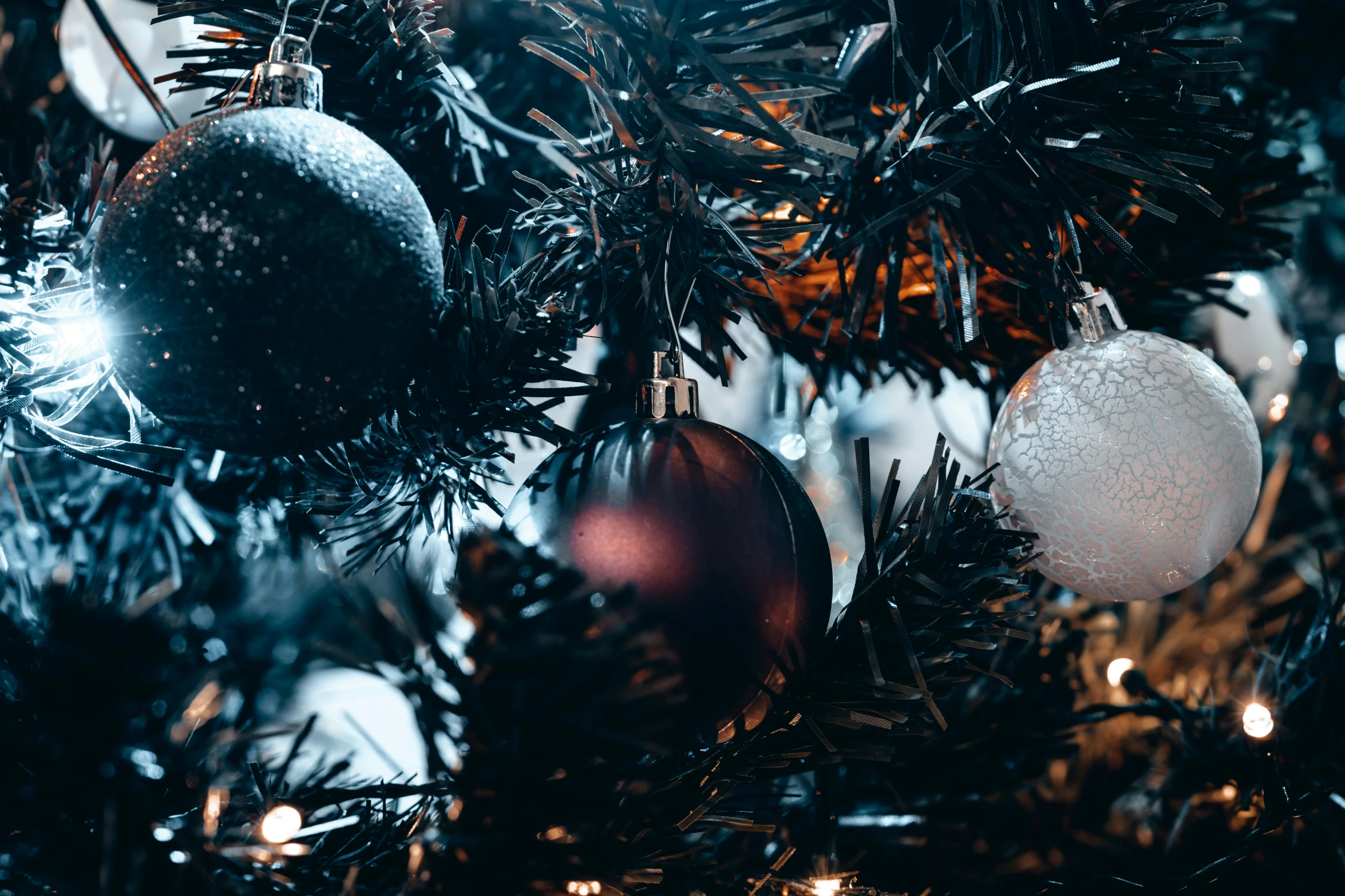 ornaments are on a tree in a dark room