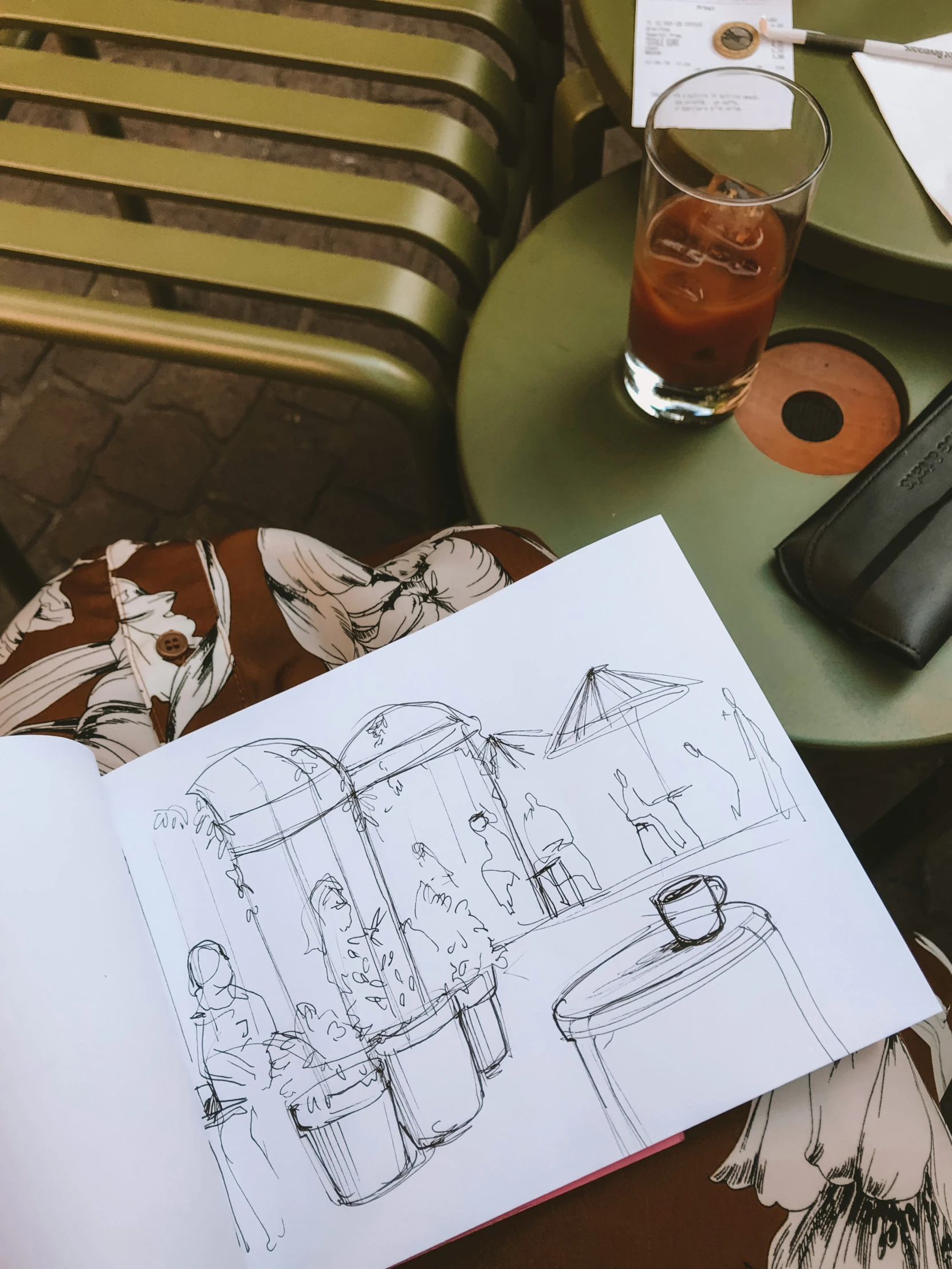 a sketch and a drink on top of a table