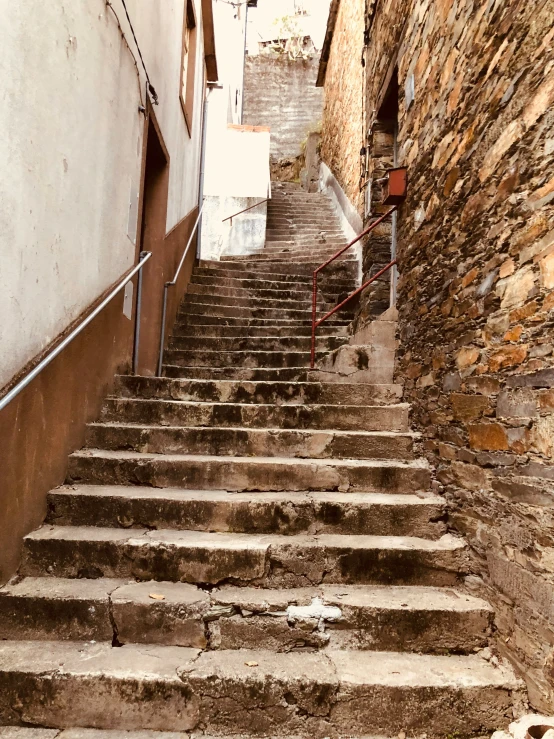 a set of stairs going up to an alley