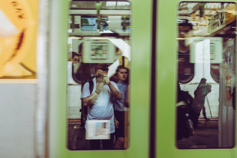 passengers on the subway train looking in mirror