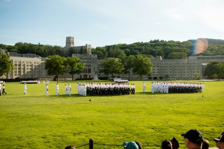 several people in white uniforms standing around a field