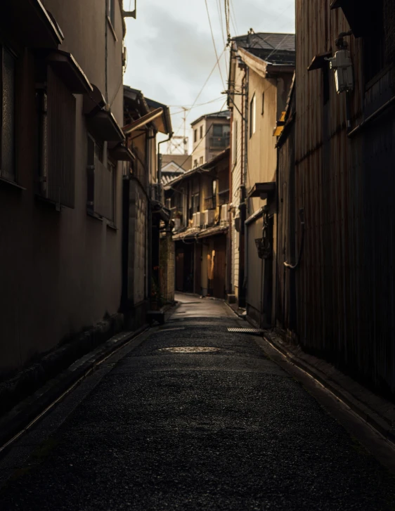 empty alleyway with a wooden building in the distance