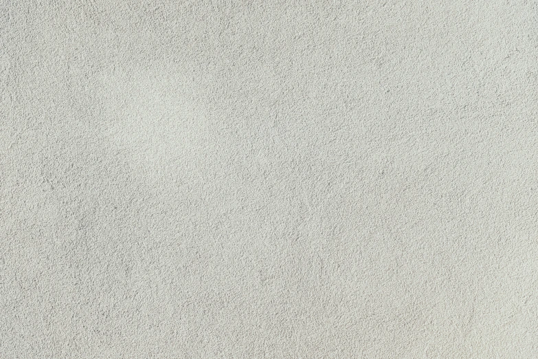 a large white wall with small black dots on it