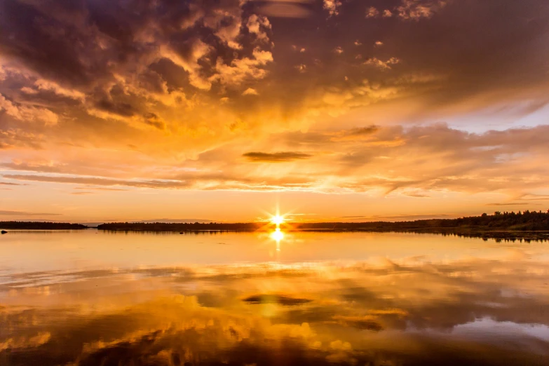 a large body of water sitting under a cloudy sky