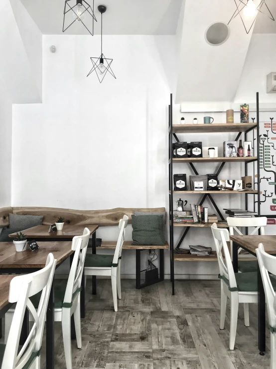 an empty dining room with wooden tables and white chairs