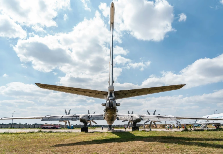 a couple people are sitting and looking at the underside of an airplane