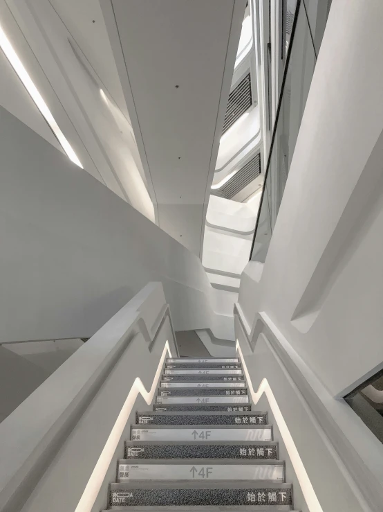 the interior of an indoor building with concrete steps and windows