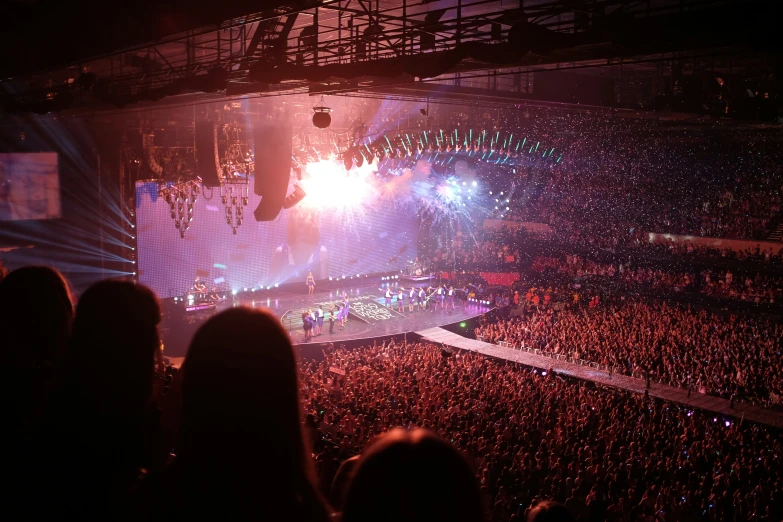 a concert scene with stage lighting in the background