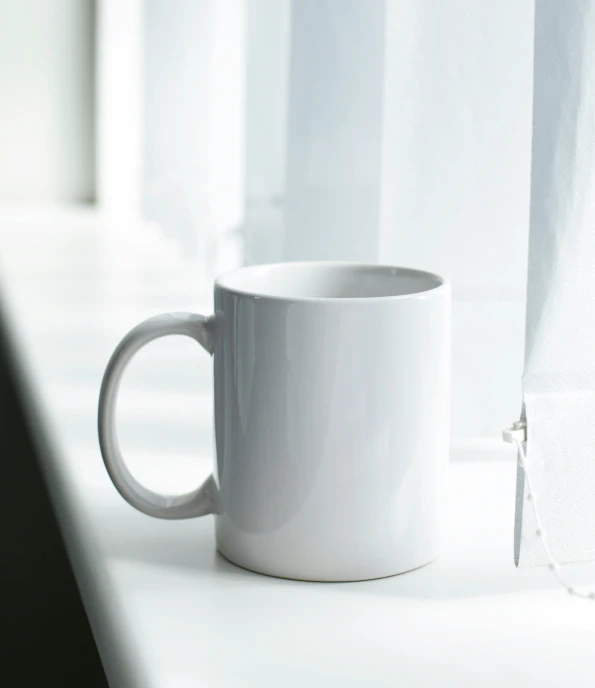 a cup of tea sitting on a window sill