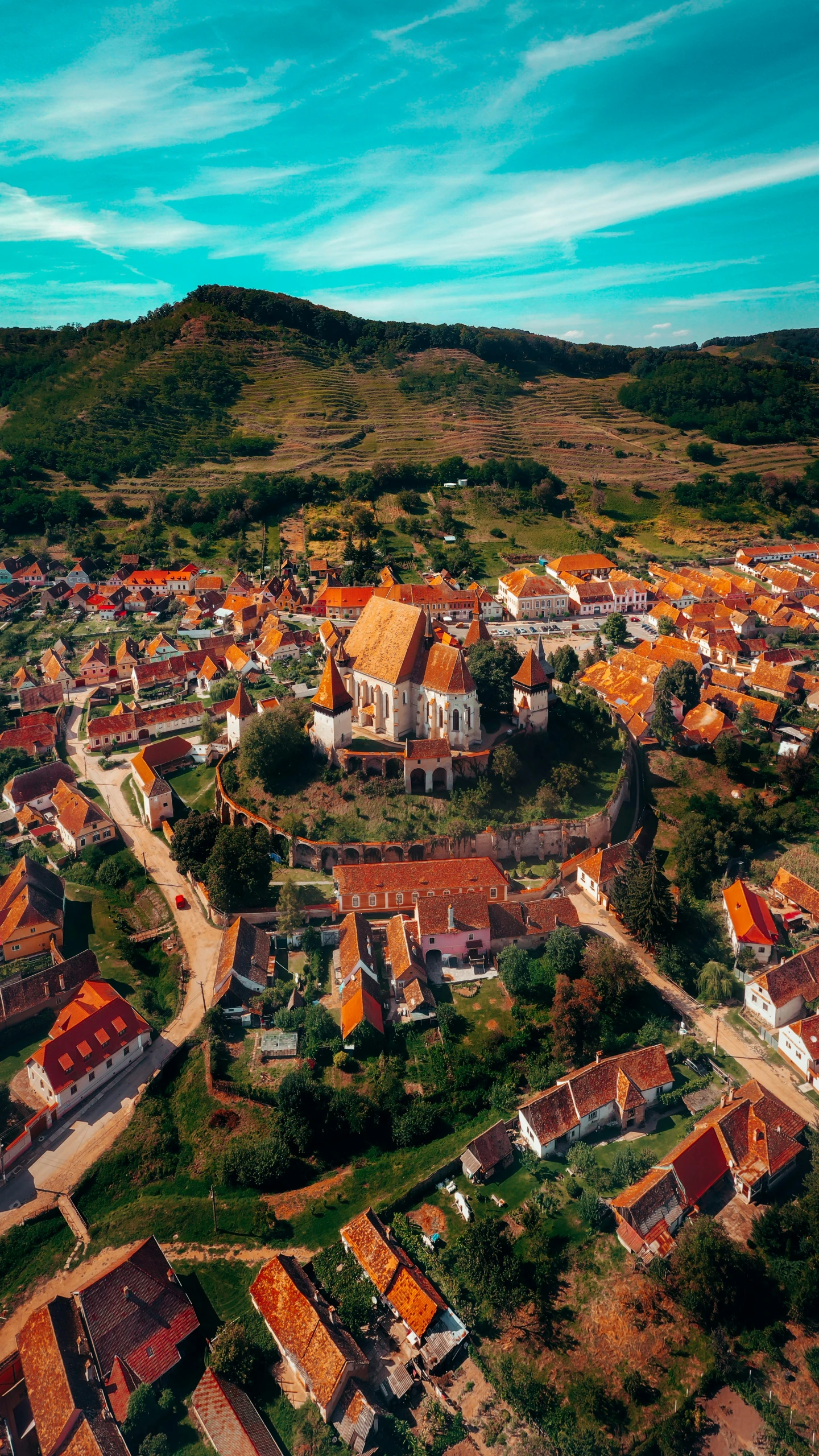 the town is on a hill and a blue sky