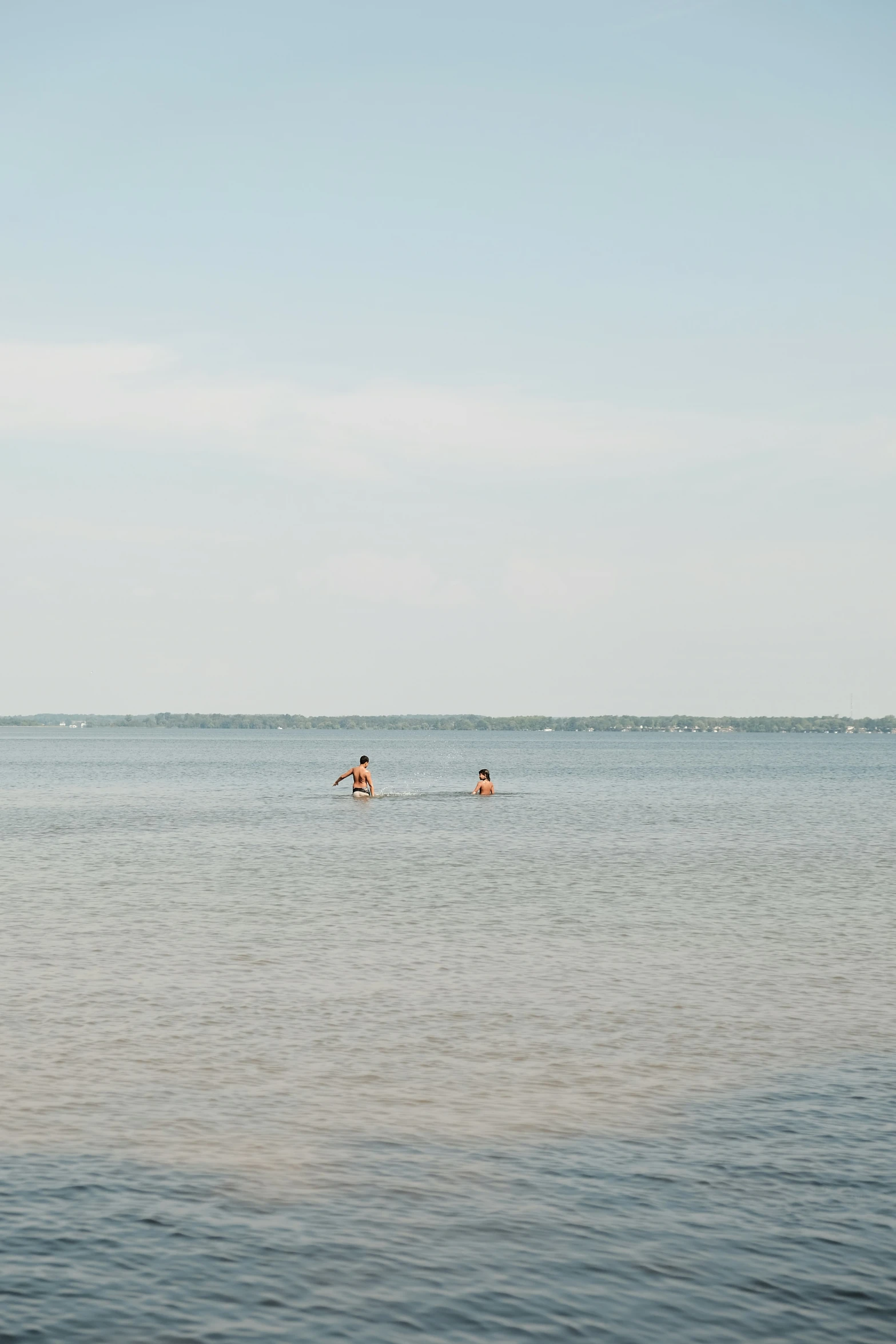 two people are out swimming in the ocean