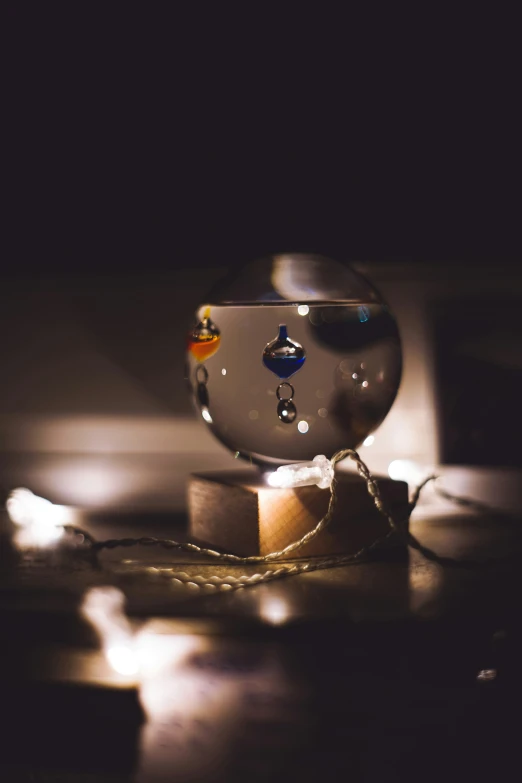 a glass ball sitting on top of a wooden block