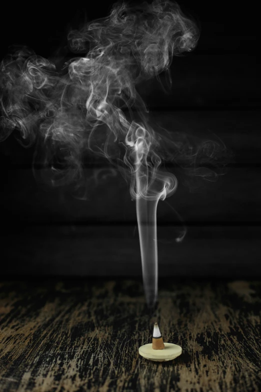 a smokestack sits on top of a wood table